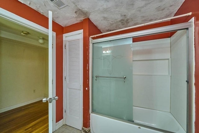 114 Mount Ida Rd Unit A, Boston, MA 02122 - bathroom with shower / bath combination with glass door, baseboards, and tile patterned floors