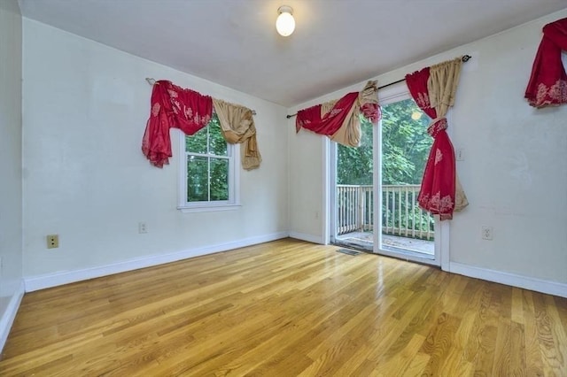 114 Mount Ida Rd Unit A, Boston, MA 02122 - empty room featuring plenty of natural light, wood finished floors, and baseboards