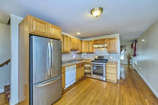 114 Mount Ida Rd Unit A, Boston, MA 02122 - kitchen featuring stainless steel appliances, under cabinet range hood, light wood-style flooring, light countertops, and tasteful backsplash