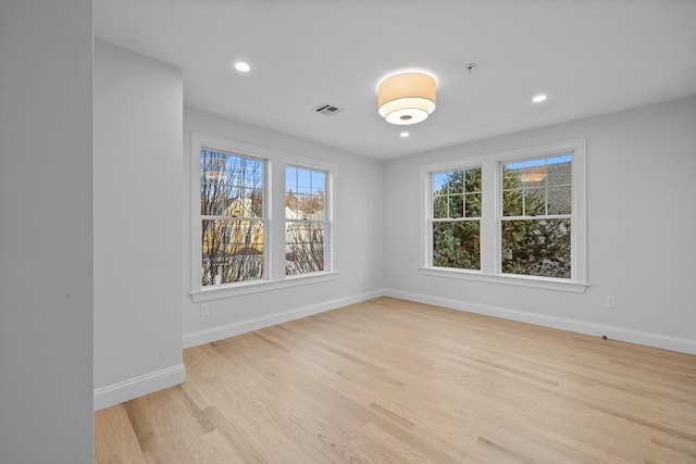 empty room with light hardwood / wood-style flooring