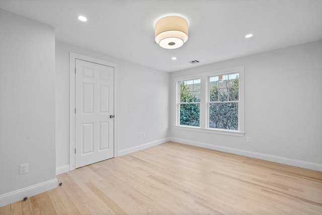 empty room with light hardwood / wood-style floors