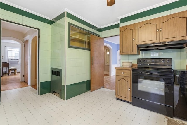 kitchen with black range with electric stovetop, radiator, ornamental molding, and ceiling fan