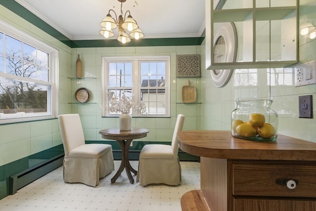 dining room with a baseboard heating unit, an inviting chandelier, tile walls, and crown molding