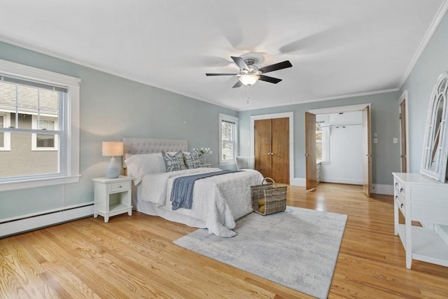 bedroom with light hardwood / wood-style flooring, ceiling fan, a baseboard heating unit, and crown molding