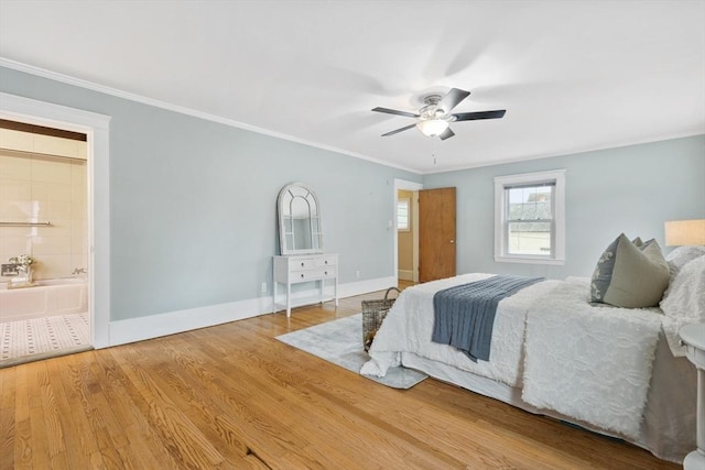 bedroom with hardwood / wood-style floors, ensuite bathroom, ceiling fan, and ornamental molding