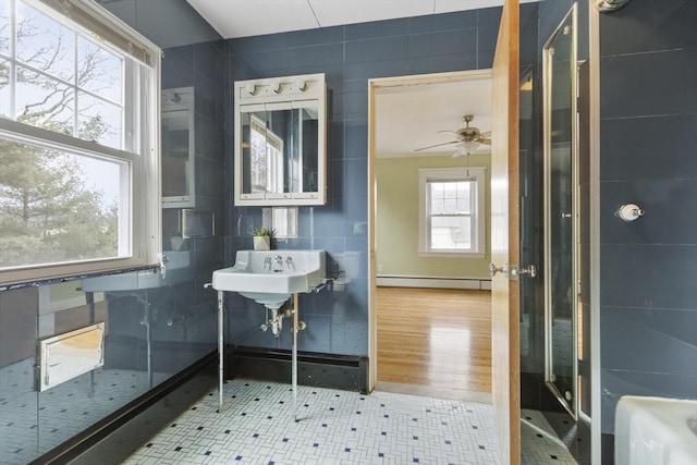 bathroom with tile patterned floors, ceiling fan, sink, and a baseboard radiator