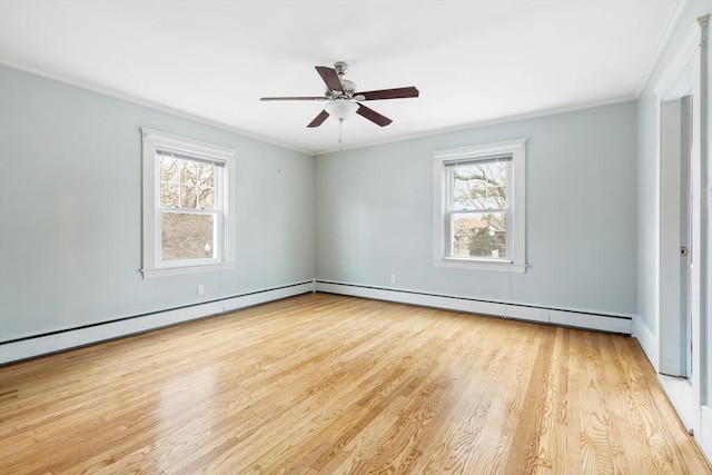 spare room with a healthy amount of sunlight, light hardwood / wood-style floors, and crown molding