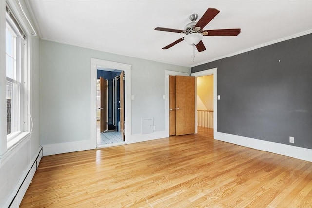 spare room featuring ceiling fan, light hardwood / wood-style floors, crown molding, and a baseboard radiator