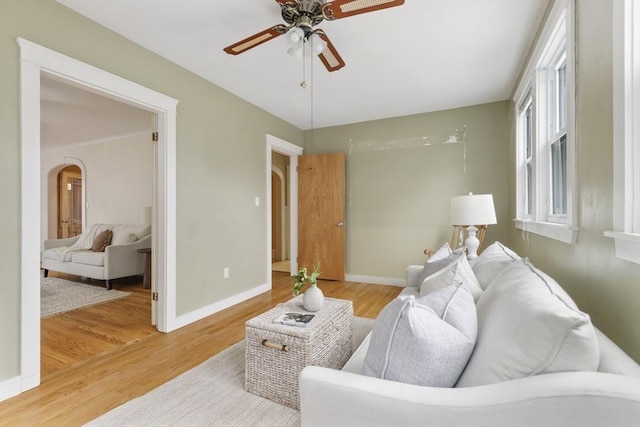 living room with hardwood / wood-style flooring and ceiling fan