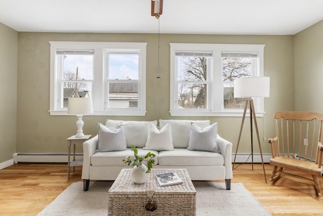 interior space with light hardwood / wood-style flooring and a baseboard heating unit