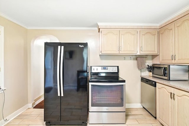 kitchen featuring light brown cabinets, ornamental molding, baseboards, and stainless steel appliances