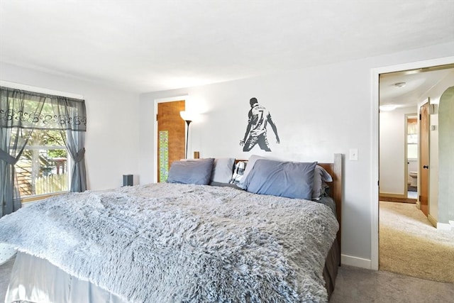 carpeted bedroom featuring baseboards