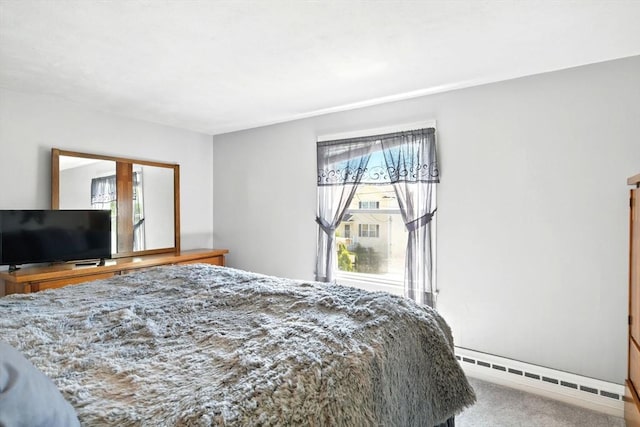 carpeted bedroom with baseboard heating