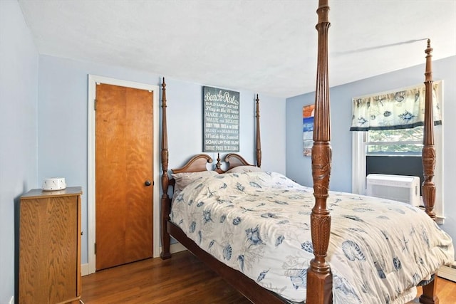 bedroom featuring baseboards, wood finished floors, and cooling unit
