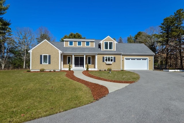 26 Crosswinds Way, Falmouth, MA 02536 - view of front of house with driveway, an attached garage, a shingled roof, and a front lawn