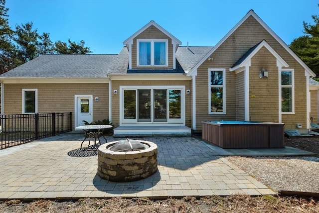 26 Crosswinds Way, Falmouth, MA 02536 - back of house with roof with shingles, fence, a hot tub, and a patio