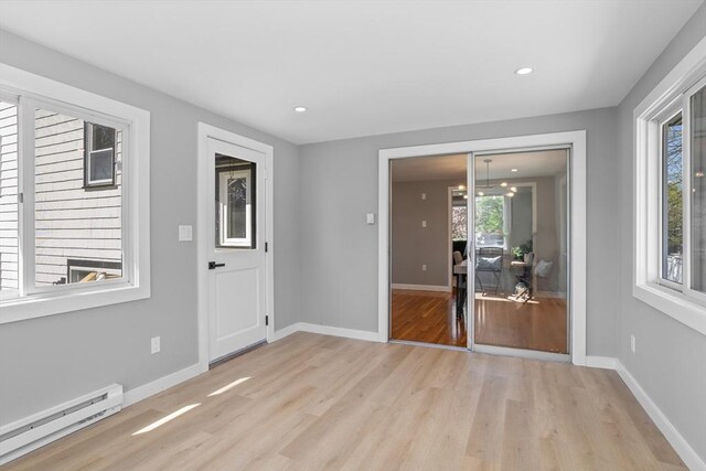 interior space featuring light wood-style floors, recessed lighting, baseboards, and baseboard heating