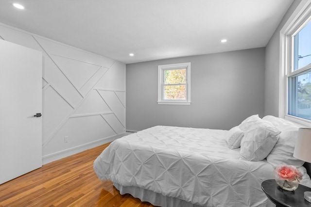 bedroom featuring recessed lighting and wood finished floors