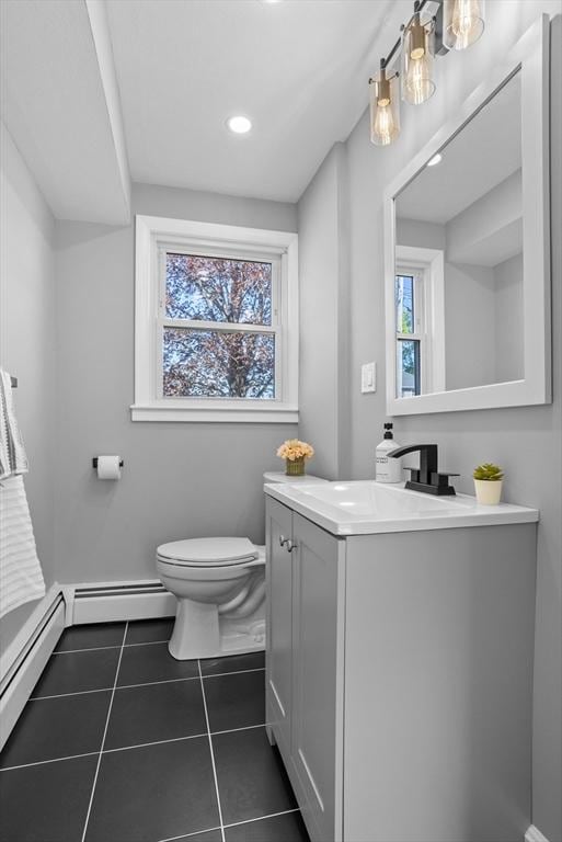bathroom featuring vanity, plenty of natural light, toilet, and tile patterned flooring