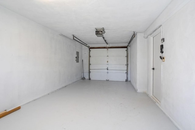garage with a garage door opener and electric panel
