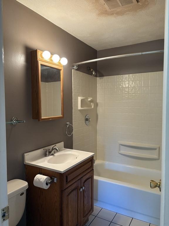 740 Central St Unit J11, Leominster, MA 01453 - full bath featuring shower / bathtub combination, vanity, tile patterned flooring, and a textured ceiling