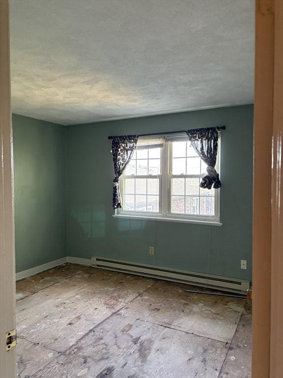 740 Central St Unit J11, Leominster, MA 01453 - unfurnished room featuring a baseboard heating unit and a textured ceiling
