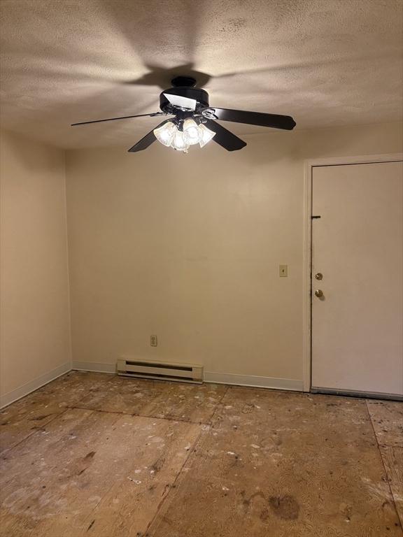 740 Central St Unit J11, Leominster, MA 01453 - spare room with a baseboard radiator, a textured ceiling, and a ceiling fan