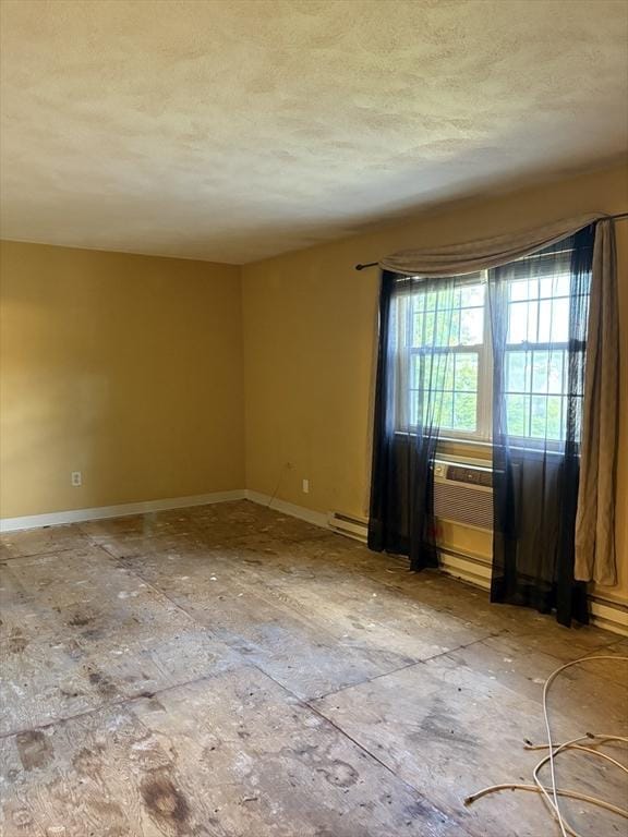 740 Central St Unit J11, Leominster, MA 01453 - spare room featuring a textured ceiling and a baseboard heating unit