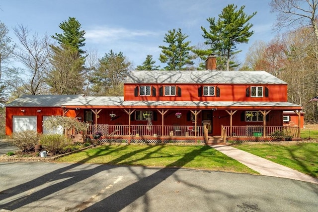 view of front of home with a chimney, a porch, and a front yard