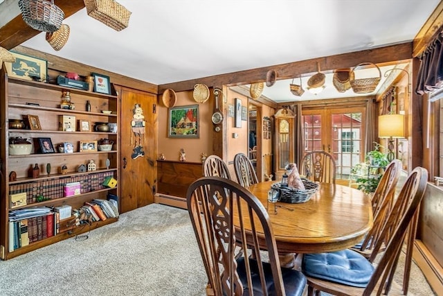 carpeted dining space featuring french doors and a baseboard heating unit