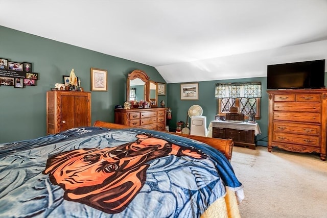 carpeted bedroom featuring a baseboard heating unit and lofted ceiling