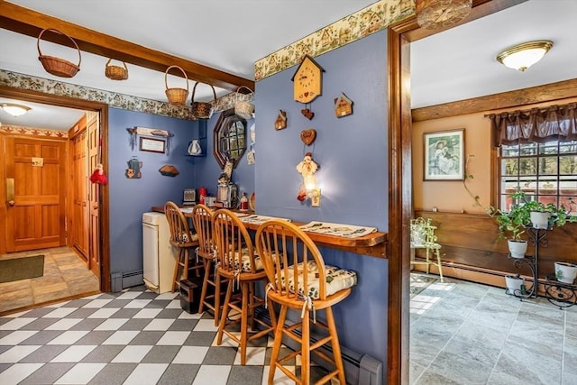 bar with a dry bar, a baseboard radiator, and beamed ceiling