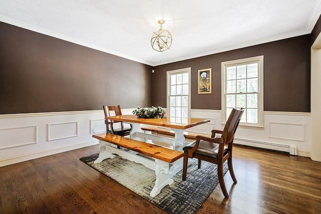 dining area featuring ornamental molding, dark hardwood / wood-style flooring, a chandelier, and a baseboard heating unit