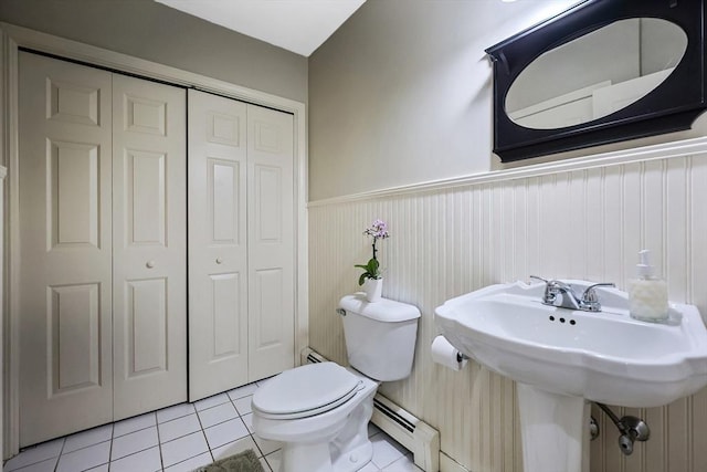 bathroom with tile patterned floors, toilet, and baseboard heating