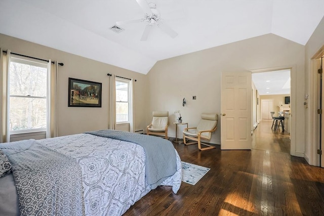 bedroom featuring dark wood-type flooring, vaulted ceiling, and ceiling fan