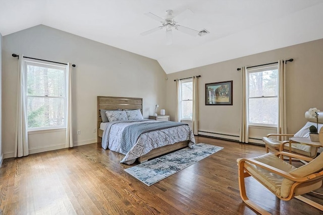 bedroom with multiple windows, vaulted ceiling, and hardwood / wood-style floors