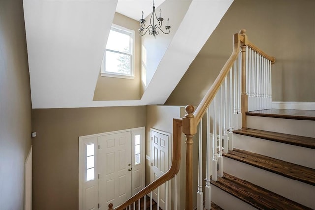 foyer entrance with a notable chandelier