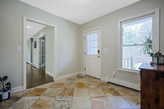 foyer with a baseboard heating unit and a wealth of natural light