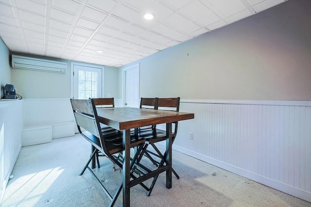 carpeted dining area featuring a wall mounted AC