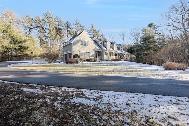 view of snow covered exterior with a garage