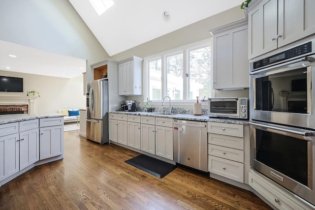 kitchen featuring white cabinetry, appliances with stainless steel finishes, and light stone countertops