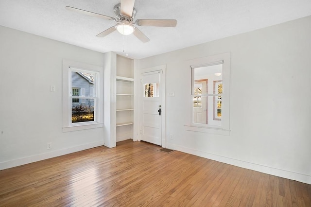 unfurnished room with hardwood / wood-style flooring and ceiling fan