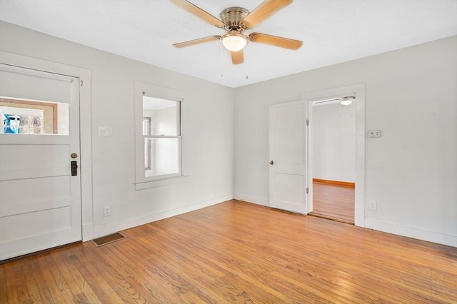 foyer with ceiling fan and light wood-type flooring