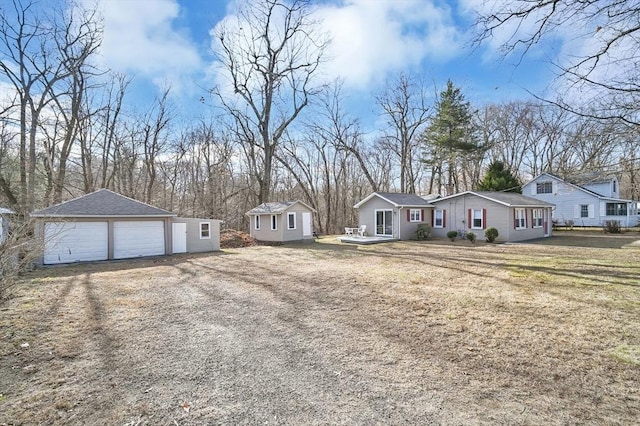 view of front of home with a front lawn, a garage, and a storage unit