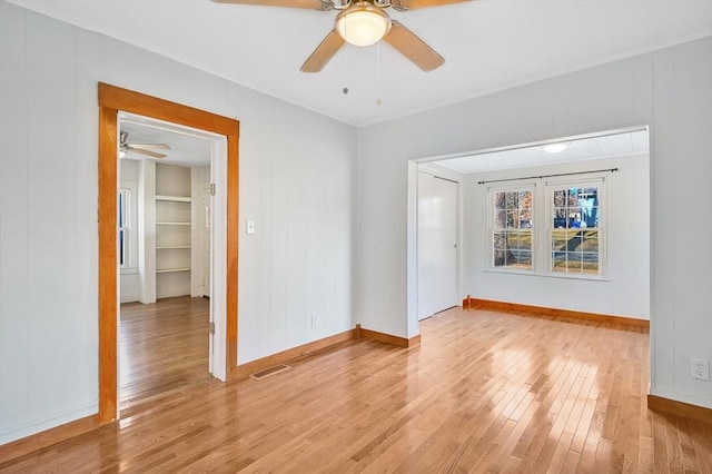 empty room featuring ceiling fan and light wood-type flooring