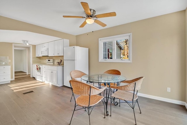 dining room featuring ceiling fan and light wood-type flooring