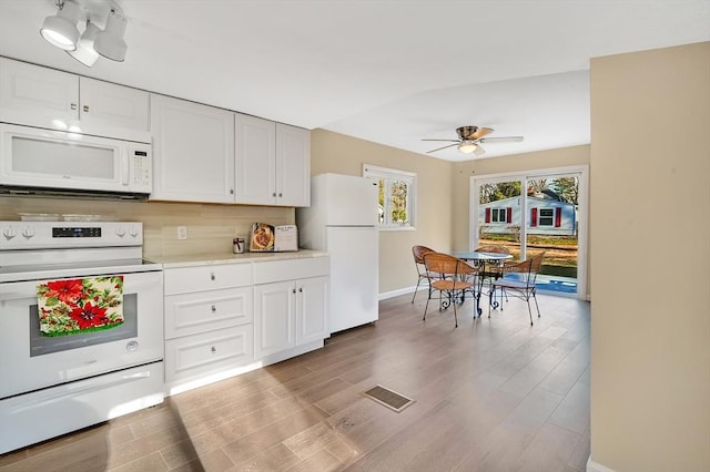 kitchen featuring white cabinets, ceiling fan, light hardwood / wood-style floors, and white appliances