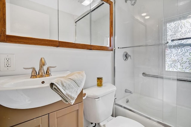 full bathroom with vanity, toilet, and enclosed tub / shower combo