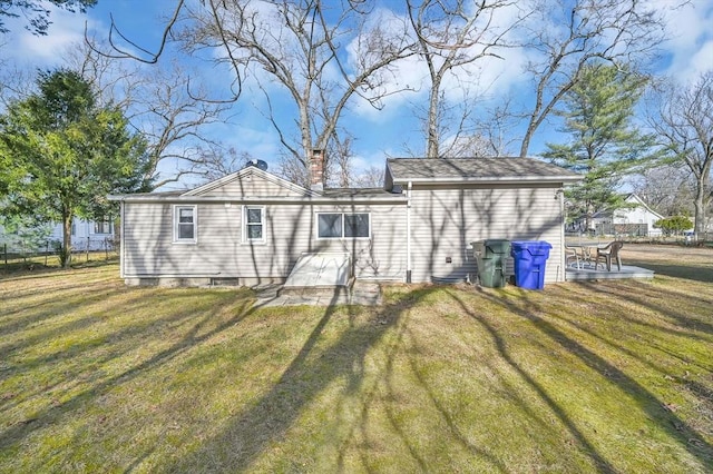 back of house with a lawn