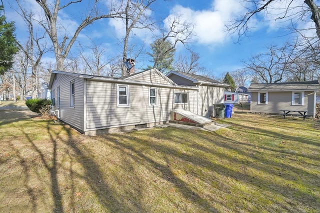 rear view of property with a lawn